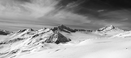 Image showing Black and white panorama of snow mountains in winter evening