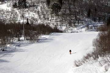 Image showing Skier on ski slope at sunny winter day