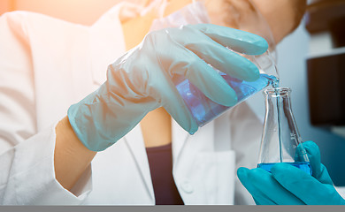 Image showing Girl conducts experiments with bulb