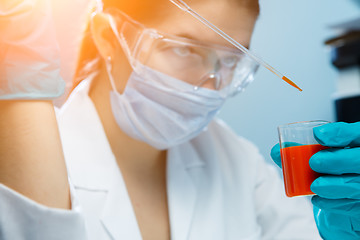 Image showing Girl in lab coat , glasses ,