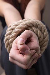 Image showing Tied rope hands of girl