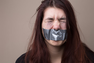 Image showing Woman with tape on face