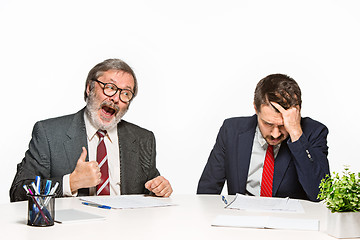 Image showing The two colleagues working together at office on white background.