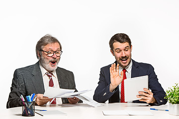 Image showing The two colleagues working together at office on white background.