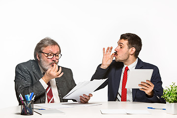 Image showing The two colleagues working together at office on white background.