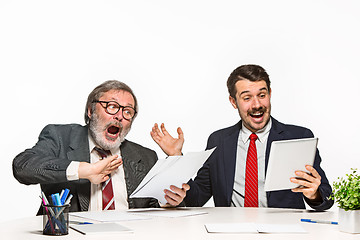 Image showing The two colleagues working together at office on white background.