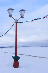 Image showing Street lamp on embankment of frozen lake