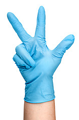 Image showing Hand in blue latex glove showing three fingers vertically