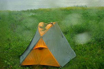 Image showing Rainy day. Drops poured glass window and tent of lone camper 1