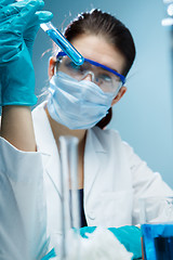 Image showing Lab assistant experiments with reagents