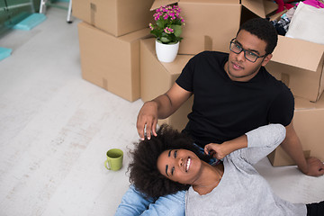 Image showing African American couple relaxing in new house