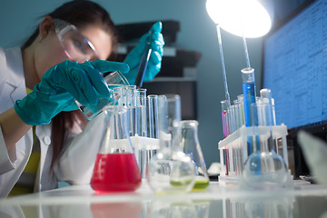 Image showing Young girl carries chemical reactions