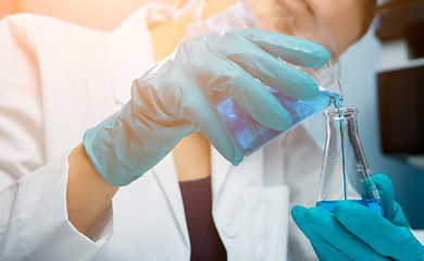 Image showing Girl conducts experiments with bulb