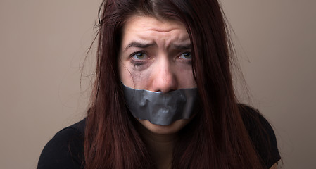 Image showing Frightened girl hostage with tape