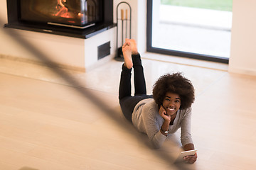 Image showing black women used tablet computer on the floor