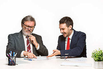 Image showing The two colleagues working together at office on white background.