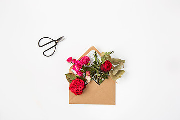 Image showing Love or valentine\'s day concept. Red beautiful roses in envelopen