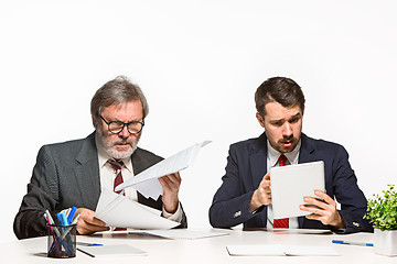 Image showing The two colleagues working together at office on white background.