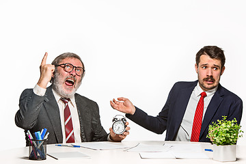 Image showing The two colleagues working together at office on white background.