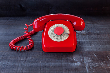 Image showing Retro Vintage red landline unhang on wooden background