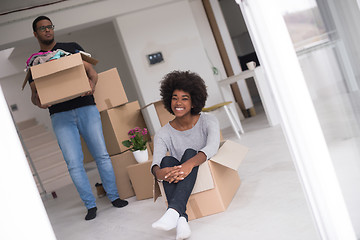 Image showing African American couple  playing with packing material