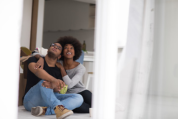 Image showing African American couple relaxing in new house