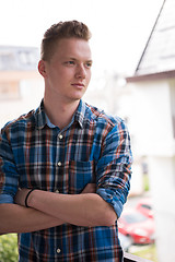 Image showing man standing at balcony