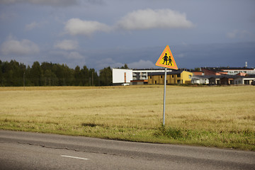 Image showing road sign caution children against the town