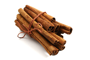 Image showing bunch of cinnamon sticks on a white background