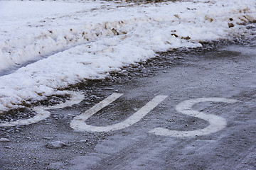 Image showing inscription BUS on the icy road surface