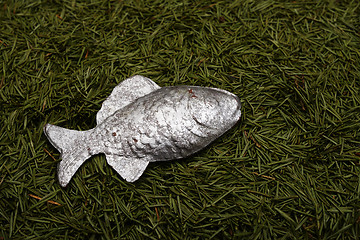 Image showing Christmas background of fur-tree needles and toy fish