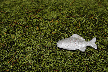 Image showing Christmas background of fur-tree needles and toy fish