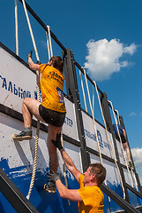 Image showing Athletes storm wall in extrim race. Tyumen.Russia