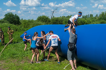 Image showing Athletes overcome inflatable obstacle. Tyumen