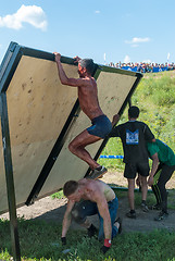 Image showing Athletes storm wall in extrim race. Tyumen.Russia