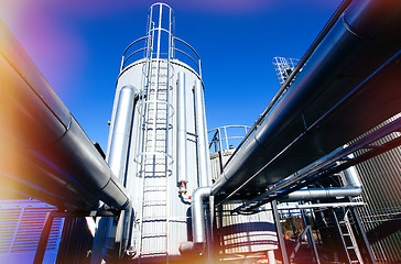 Image showing Industrial zone, Steel pipelines and valves against blue sky