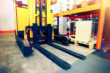 Image showing Shelves, racks and forklift  with pallets in distribution wareho