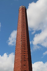 Image showing  High brick smokestack in the blue sky