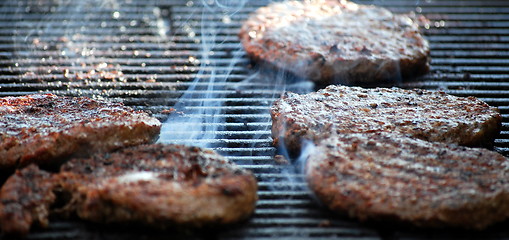 Image showing Burgers on grill.