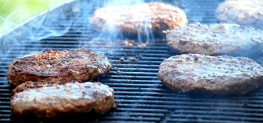 Image showing Burgers on grill.
