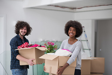 Image showing multiethnic couple moving into a new home