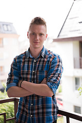 Image showing man standing at balcony