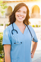 Image showing Portrait of Young Adult Female Doctor or Nurse Wearing Scrubs an