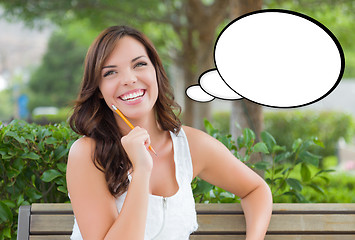 Image showing Thoughtful Young Woman with Pencil and Blank Thought Bubble.