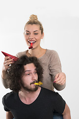 Image showing couple in party hats blowing in whistle