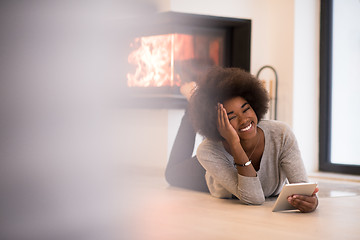 Image showing black women used tablet computer on the floor