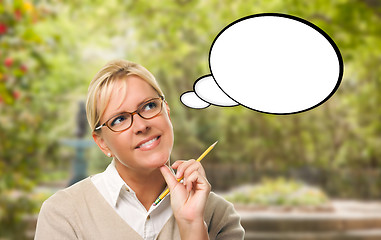 Image showing Thoughtful Young Woman with Pencil and Blank Thought Bubble.