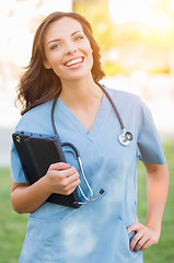 Image showing Portrait of An Attractive Young Adult Woman Doctor or Nurse Hold