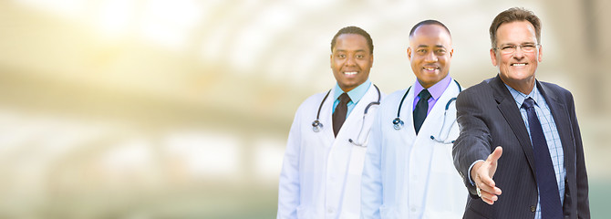 Image showing Caucasian Businessman and African American Male Doctors, Nurses 