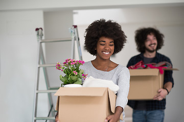 Image showing multiethnic couple moving into a new home